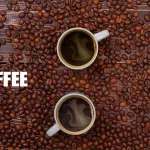High-quality Arabica and Robusta coffee beans with a steaming cup on a wooden table